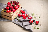 Red ripe cherries in small wooden box