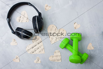 Flatlay sport music composition headphones paper hearts dumbbell
