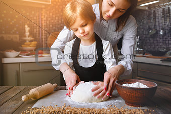 Woman cooking with little girl