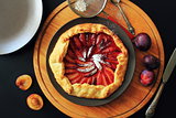 Delicious fresh homemade plum galette on table