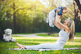 Delighted mother with her son outdoors in a park