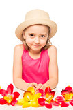  little girl and a bunch of exotic flowers on a table on a white