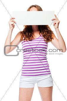 Red-haired girl hides her face behind the poster