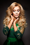 Portrait of elegant sexy blonde woman with long curly hair and glamour makeup.