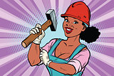 Construction worker with hammer. Woman professional