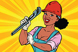 Construction worker with adjustable wrench. Woman professional