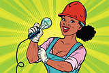 Construction worker with light bulb. Woman professional