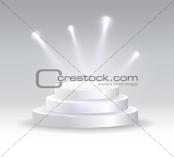 Round podium illuminated by spotlights.