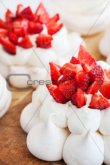 Pavlova meringue cake decorated with fresh strawberries