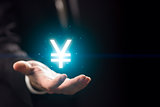 Businessperson hand holding yen symbol