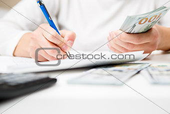 Entrepreneur calculating and reviewing investment plan