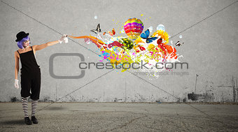 Woman clown with colored spray