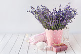 spa massage setting, lavender product, oil on wooden background