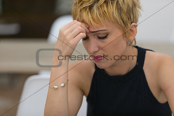 Worried young woman with a tension headache