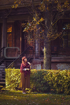 Girl standing near old house