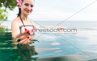 Woman in vacation relaxing swimming in pool