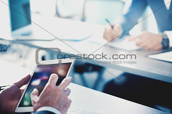 Businessman works with tablet during a meeting