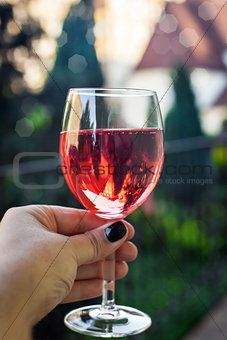 Glass of rose wine in woman hand