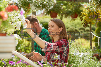 Man and woman with flowers in garden