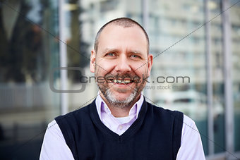 Smiling man in front of the building