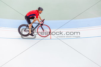 Racing cyclist on velodrome outdoor