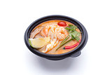 Miso soup in a black plastic dish