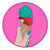 Hand holds a waffle cone with a colorful balls of an ice cream
