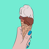 Hand holds a waffle cone with a balls of an ice cream
