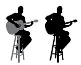 Guitar player sitting on a bar stool