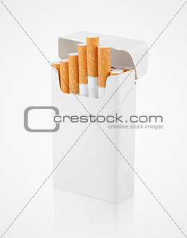 Open pack of cigarettes on gray