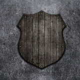 3D wooden shield on a grunge background