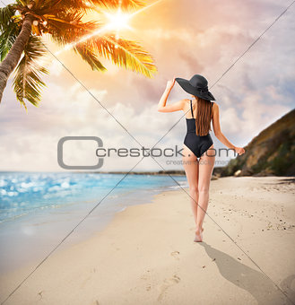 Woman walks in a tropical beach