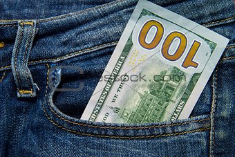 One hundred American dollars bill in the pocket of blue jeans