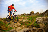Cyclist Riding Mountain Bike on the Beautiful Spring Rocky Trail. Extreme Sport Concept