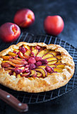 Galette with peach and raspberry on dark
