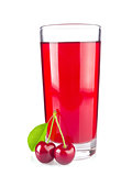 Glass juice and two ripe juicy cherries with green leaf