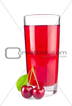 Glass juice and two ripe juicy cherries with green leaf