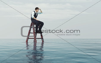 Young  man sits on a ladder 