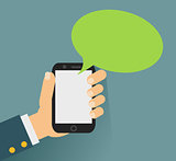 Hand holing smartphone with blank speech bubble for text.