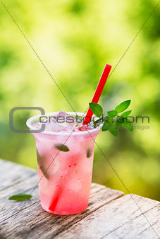 Refreshing berry drink with ice and mint.