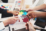 Team of businessmen work together to build a puzzle. Concept of unity and partnership