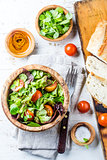 Vegetarian salad with lettuce and tomatoes in olive wooden bowl
