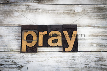 Pray Letterpress Word on Wooden Background