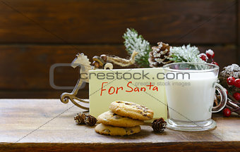 Cookies and a glass of milk for Santa. Christmas decorations