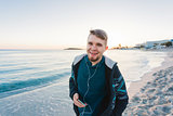 handsome portrait man listening to music smartphone, happy face, beard, beach, sea, travel, internet, Outdoor portrait, hipster style, holding phone in hand. beard man