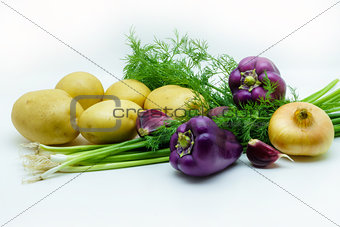 Assortment of fresh raw vegetables on white background. Selection includes potato, green onion, pepper, garlic and dill