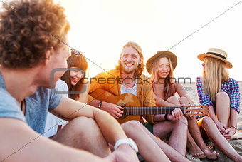 Happy group of friend having party on the beach