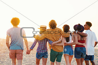 Group of happy friends having fun at ocean beach