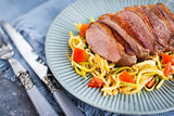 Roasted duck breast and zucchini noodles with tomatoes