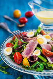 Tuna salad with tomatoes, boiled eggs, onion, anchovy and lettuc